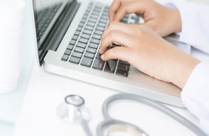 Medical personal entering info into computer